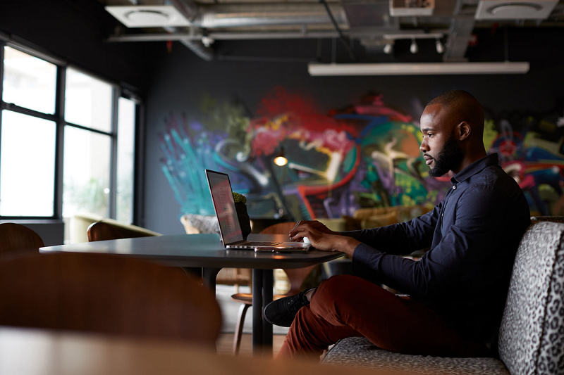 South African IT professional working remotely in a modern workspace